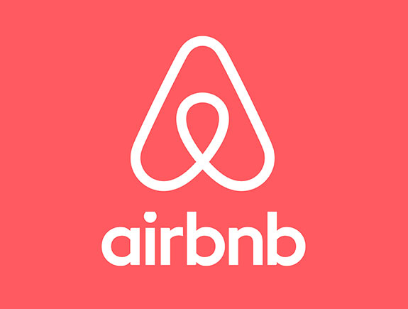 logo vertikala beli na jednobojnoj pozadini Airbnb